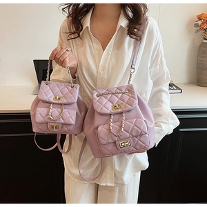 Detail of lavender quilted handbags with golden metal turn-locks and chain straps