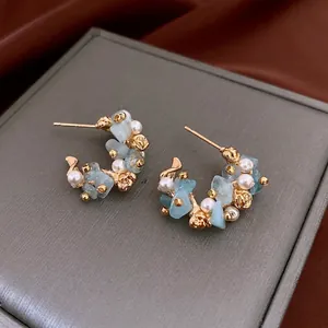 Aquamarine C-shaped flower earrings with pearls and gold floral metal details