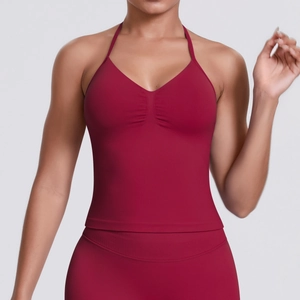 Detail view of burgundy seamless ribbed yoga set showing V-neck crop top texture