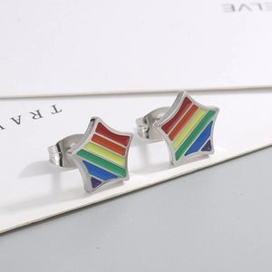 Macro shot of stainless steel star earrings with colorful rainbow enamel stripes