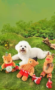 Detail of plush dog toys with Christmas elk and fox designs on a grassy lawn