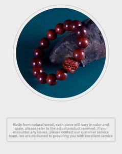 Detailed view of polished sandalwood beads and a carved lion head in a Zen setting