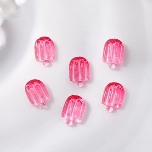 Macro detail of six pink resin popsicle nail art charms with translucent texture