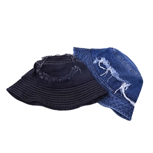 Detail of vintage denim bucket hat featuring frayed edges and circular stitching design