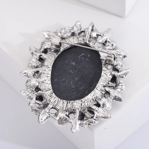 Detailed back view of vintage silver flower brooch showing the secure pin fastener