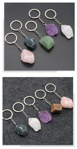 Close-up of assorted natural crystal stones on metal keychains in various colors