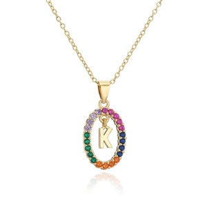 Detail of gold necklace pendant with rainbow zircon halo and 3D initial K element