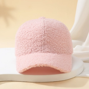Close-up of soft pink sherpa fleece texture on a stylish baseball cap for women