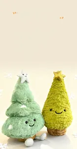 Close-up of two smiling plush Christmas trees with star toppers and soft fabric texture
