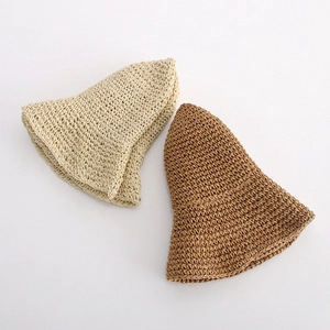 Detail of hand-woven texture on foldable sun hats in beige and light brown