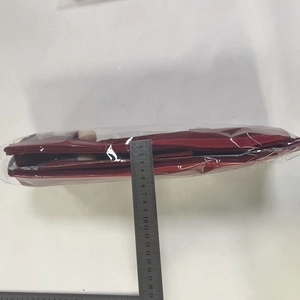 Detail view of wine red felt organizer thickness measured with a steel ruler about 5cm