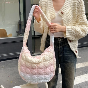 Detail of soft quilted cloud bag with pink and blue gradient and puffy texture strap