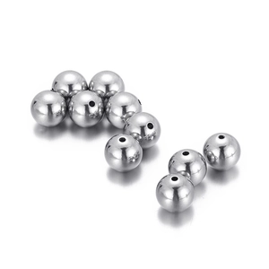 Detailed view of silver polished stainless steel loose beads with smooth reflective finish