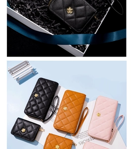 Detail of quilted leather wallets with golden camellia logo in black, brown and pink