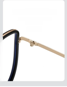 Detail of steady gold metal hinge and black cat-eye frame on blue light glasses