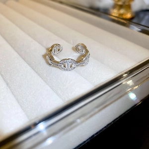 Detail of pig-nose link ring with pavé sparkling zircons in luxury velvet jewelry box