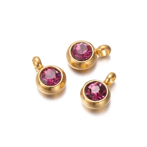 Macro shot of three round golden pendants with purple zircon stones on white background