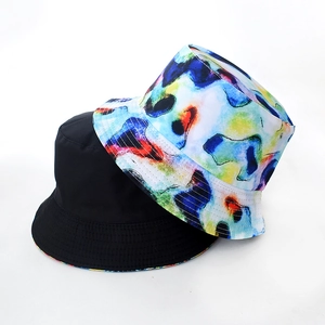 Detail view of tie-dye and solid black reversible bucket hat fabric texture