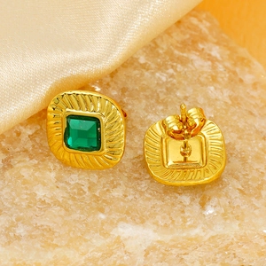 Macro view of gold stainless steel earrings with square green zircon and textured border