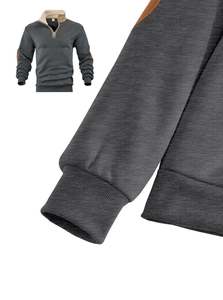 Detail of half-zip sweatshirt showing khaki elbow patches and knitted ribbed cuffs