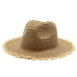 Classic straw jazz hat with frayed edges and indented top for summer beach sun protection