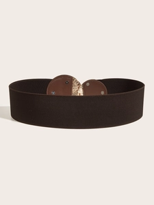 Close-up of wide elastic belt with dark brown leather and golden buckle detail