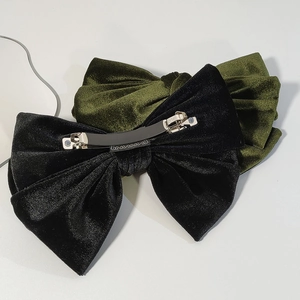 Detail of velvet bow hair clips showing elegant texture and sturdy metal spring clip back