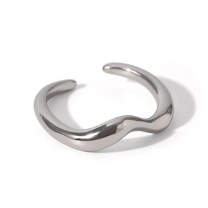 Macro shot of silver wavy stainless steel open ring with a high-polished metallic finish