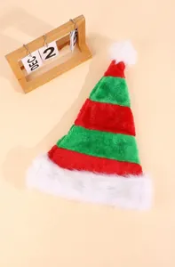 Close-up of striped red and green elf hat with plush white trim and fluffy pompom