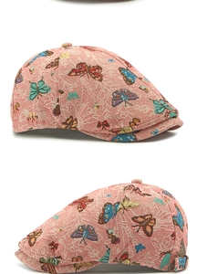 Macro detail of ethnic red beret with intricate butterfly jacquard weaving patterns