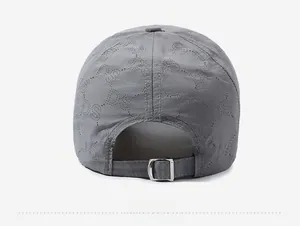 Detail view of the breathable mesh back and adjustable silver metal buckle on a grey cap
