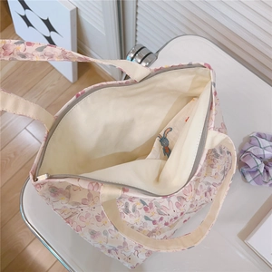Close-up of the cotton tote bag interior with zipper, inner pocket, and rabbit print