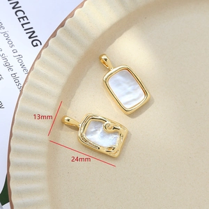 Detailed macro view of 24x13mm gold plated mother of pearl pendants for jewelry making