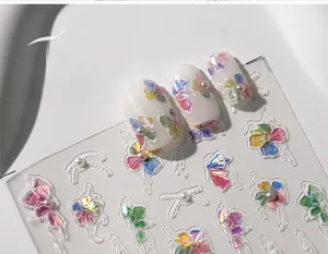 Detailed view of 3D embossed colorful floral nail stickers with white pearl accents