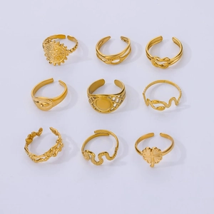 Detail of a 9-piece gold-plated snake and clover ring set with adjustable open bands