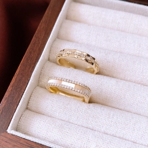 Detail of 14K gold plated rings with zircons and shell in a jewelry gift box