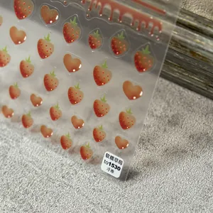 Detailed macro view of 3D embossed red strawberry and heart nail art stickers to1530