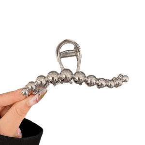 Minimalist silver metal shark hair claw clip with large beaded wave design for women