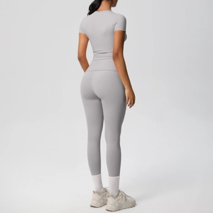 Rear view of light gray seamless fitness set featuring a short sleeve top and yoga leggings