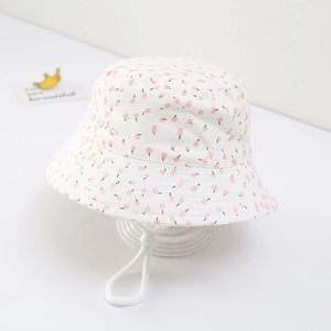 Detail of baby cotton sun hat featuring pink cherry print and adjustable chin strap