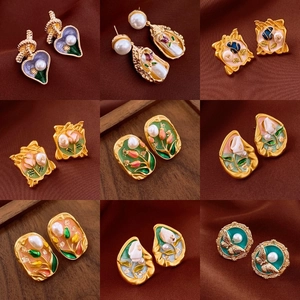 Detail showcasing vintage enamel earrings with pearl accents in French floral designs