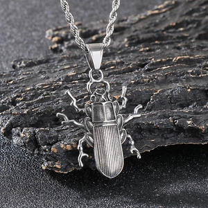 Macro shot of beetle pendant with detailed textures on a rustic rock surface