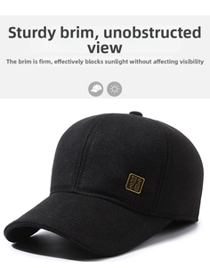 Detailed view of black wool baseball cap texture with a square golden metal logo accent