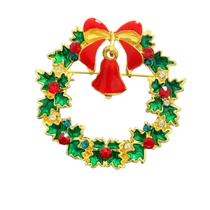 Detailed view of Christmas wreath brooch with red bow and colorful rhinestones