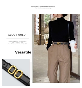 Close-up of black litchi grain leather belt with double ring golden buckle