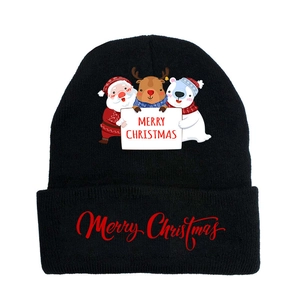 Close-up of black knitted beanie featuring festive Santa and reindeer cartoon patterns