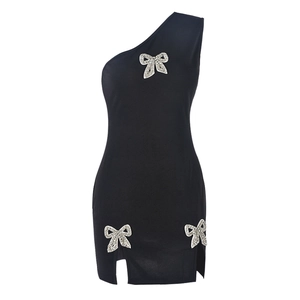 Close-up of black one-shoulder mini dress featuring three rhinestone bows and side slits