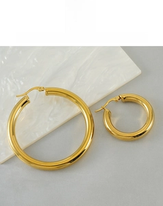 Close-up of polished 18K gold-plated hollow hoop earrings with sleek mirror finish