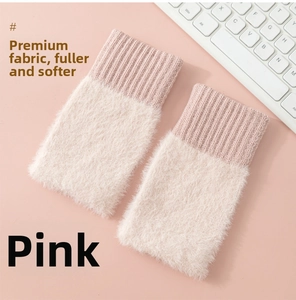 Detailed texture of pink plush knitted fingerless gloves with ribbed wrist cuffs