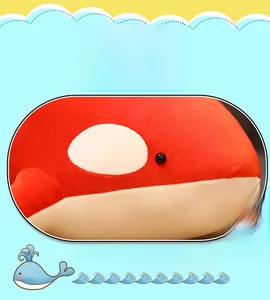 Detail view of the soft red and white plush whale toy featuring realistic black eyes
